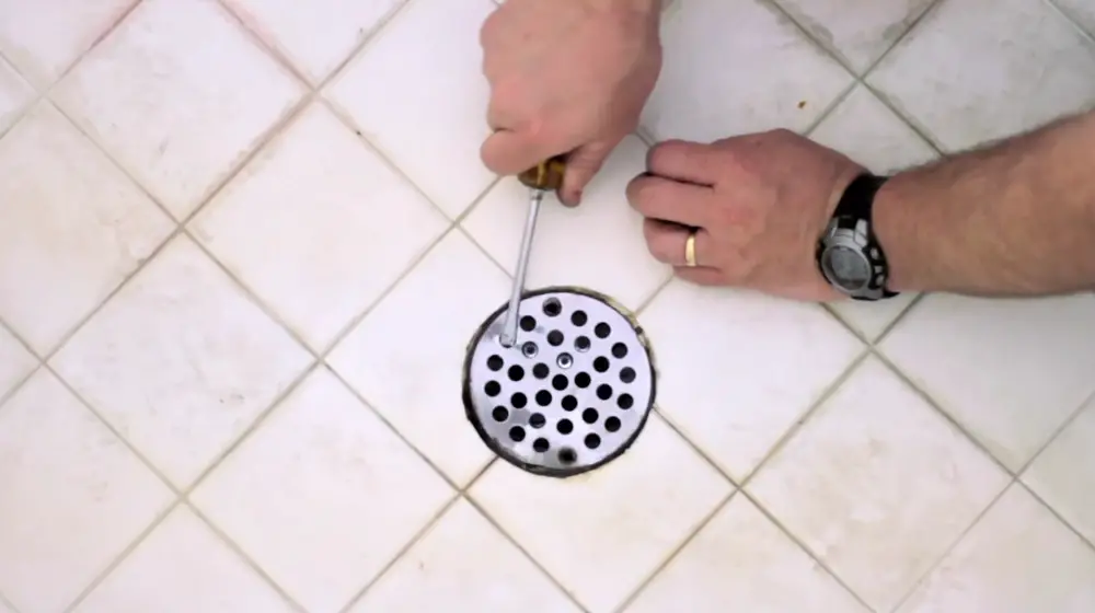 Opening a shower drain to unclog
